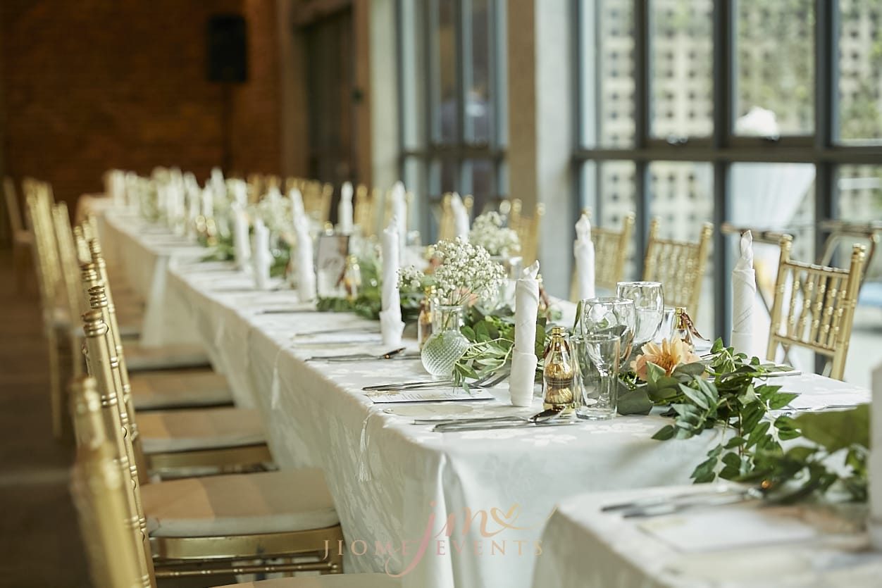 Banquet table with candles and greenery